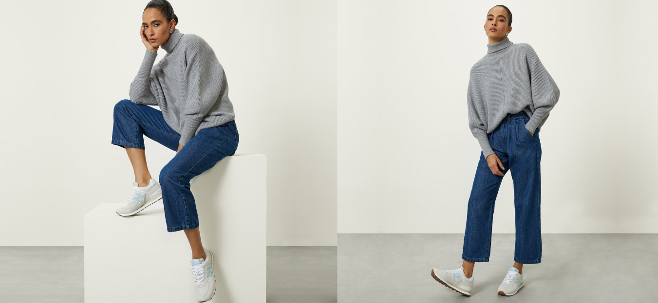 modelo posando de calça jeans e tricot com tênis branco representando looks elegantes com tênis