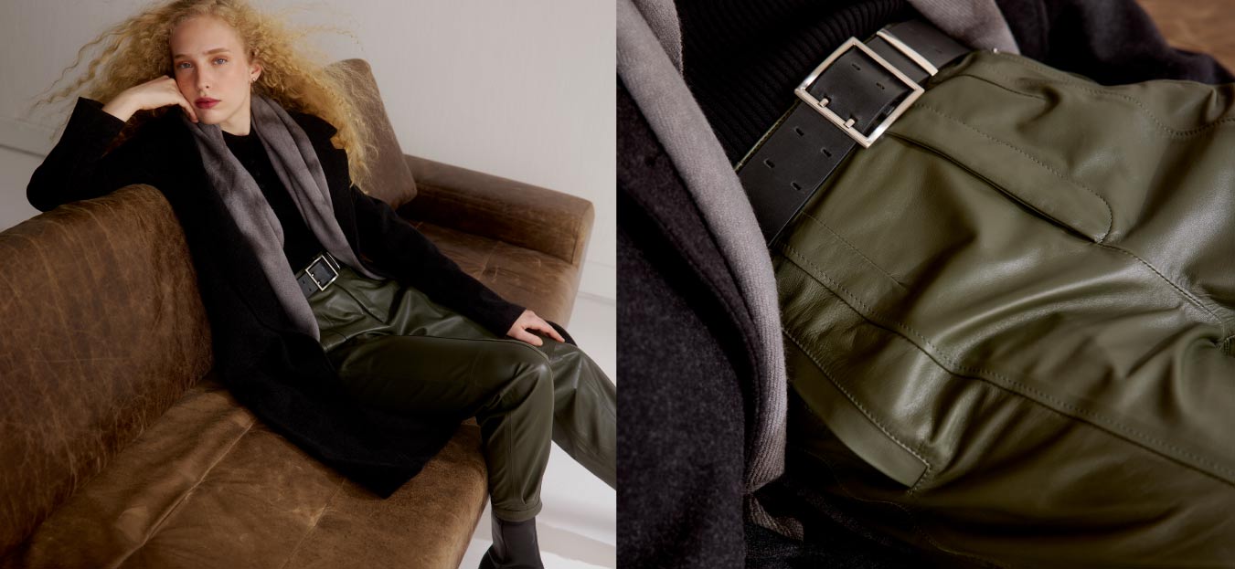 Modelo com calça de couro verde, cinto preto e blusa preta.